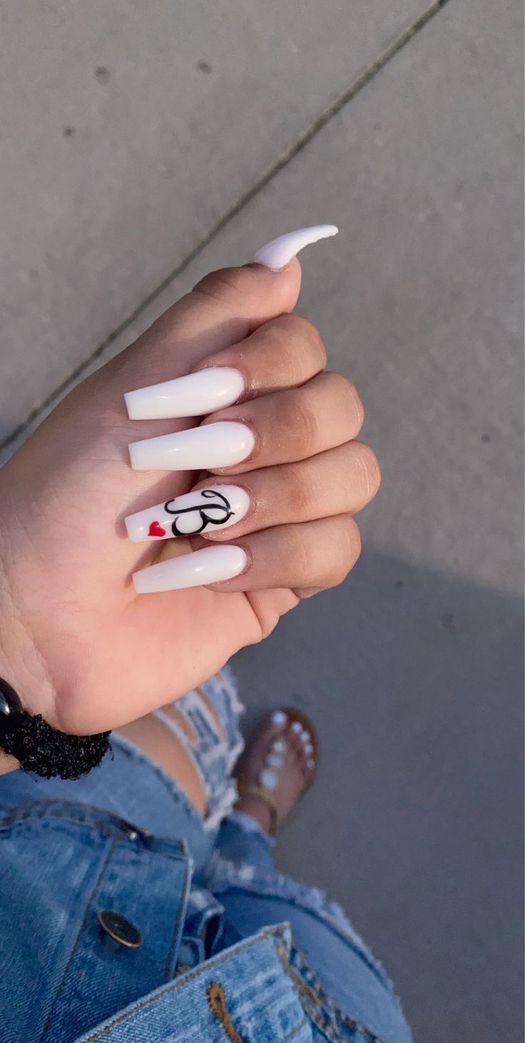 Chic Glossy White Nails with Playful Graphic Detail for a Trendy Statement.