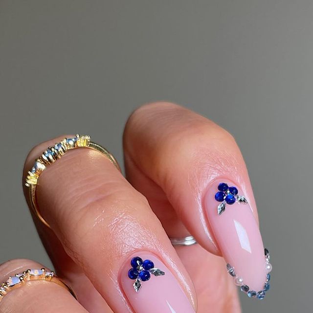 Chic Delicate Floral Nail Design with Nude Base and Sparkling Accents.