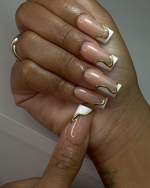 Chic Nude and White Nail Design with Delicate Golden Wave Accents