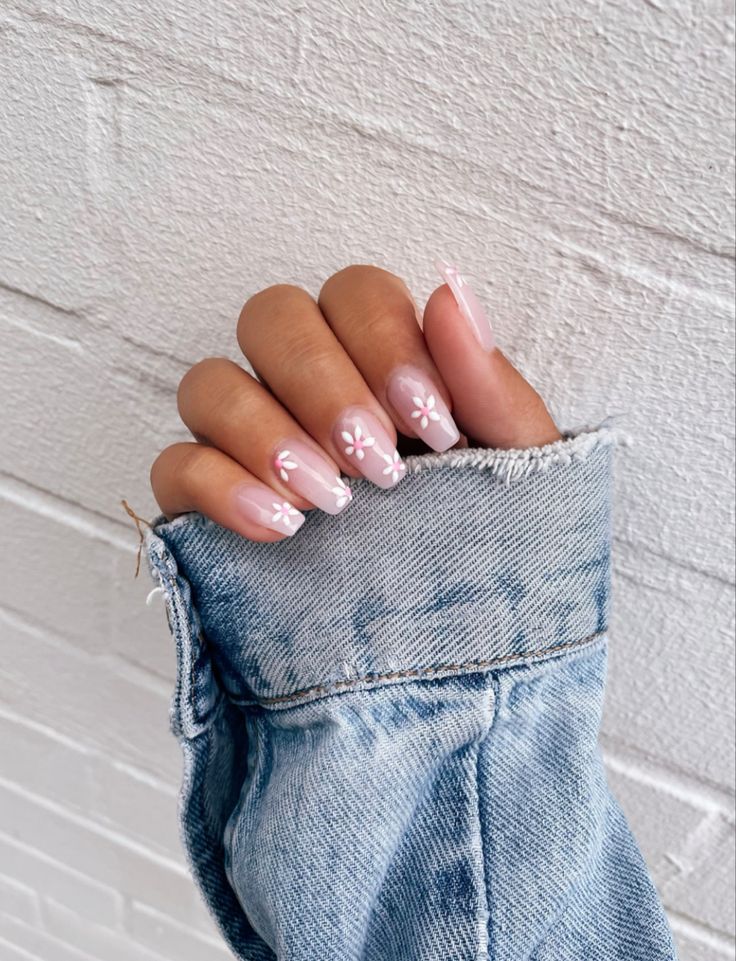 Charming Floral Nail Design: Soft Pink Base with White Daisies for a Fresh Spring Look