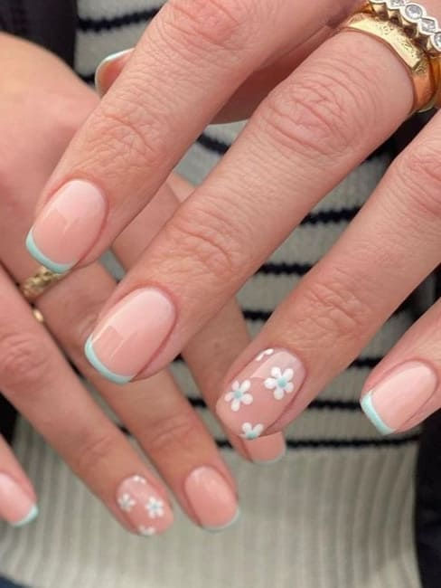 Elegant Chic Nail Design with Soft Pink Base and Pastel Blue Floral Accents for Spring/Summer.