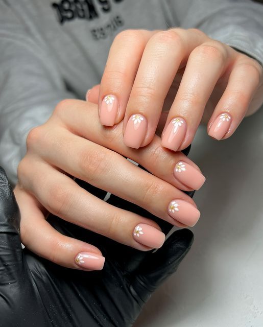 Sophisticated Soft Pink Nail Design with Delicate White Embellishments for Any Occasion.