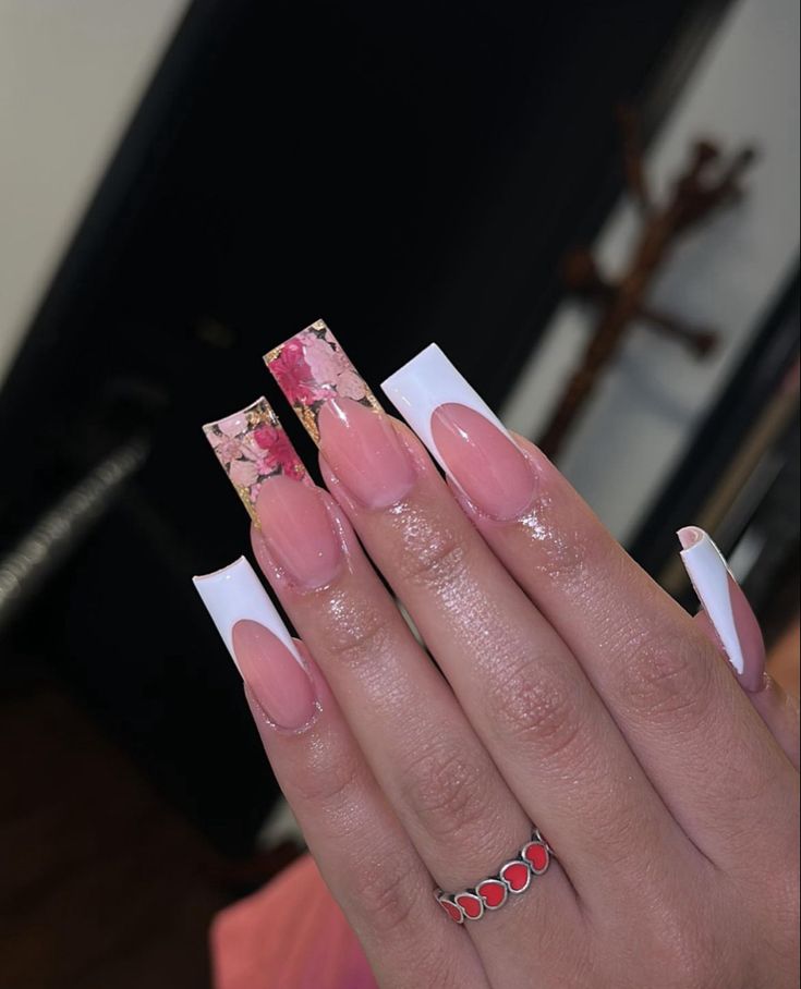 Sophisticated Nail Design: Soft Nude and Bold White Tips with Glamorous Pink and Gold Marble Accents.