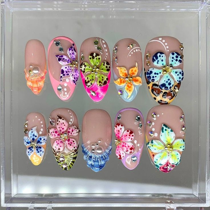 Vibrant Floral Nail Art Designs Enhanced with Glamorous Rhinestones for a Playful Look.