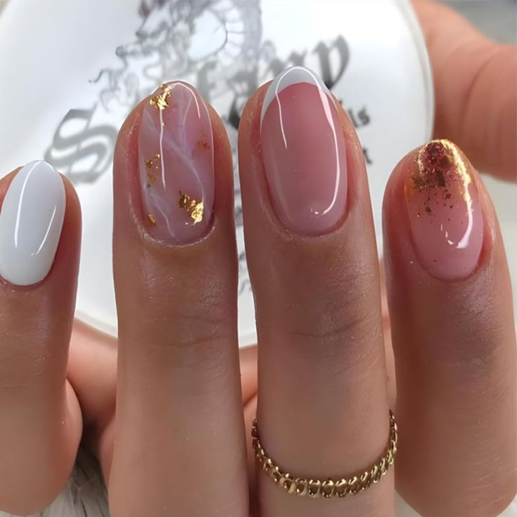 Chic Nail Design: Glossy White and Soft Pink with Elegant Gold Flakes and Unique Marbling.