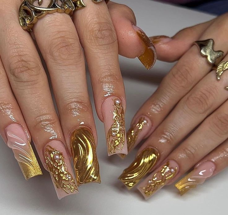 Sophisticated Nail Design: Luxurious Nude and Gold Accents with Intricate Patterns