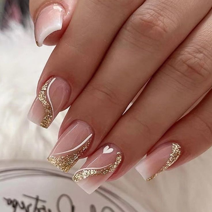 Romantic Elegant Nail Design: Soft Pink Base with Golden Glitter and Heart Detail