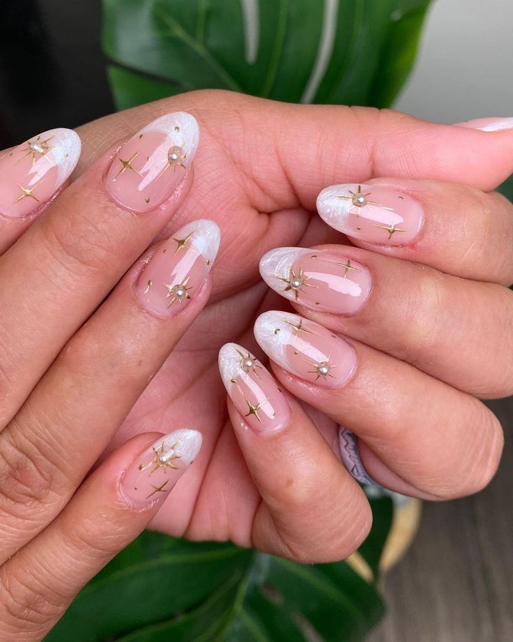 Sophisticated Nude Nail Design with Delicate White Tips and Gold Accents