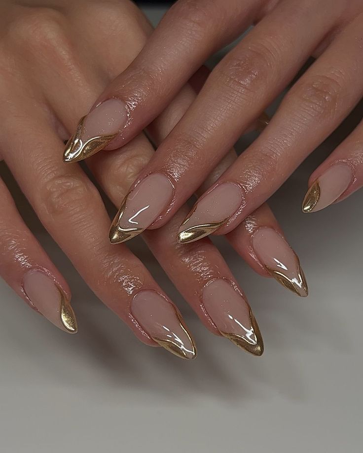 Sophisticated Elongated Nail Design with Sheer Base and Gold Accents.