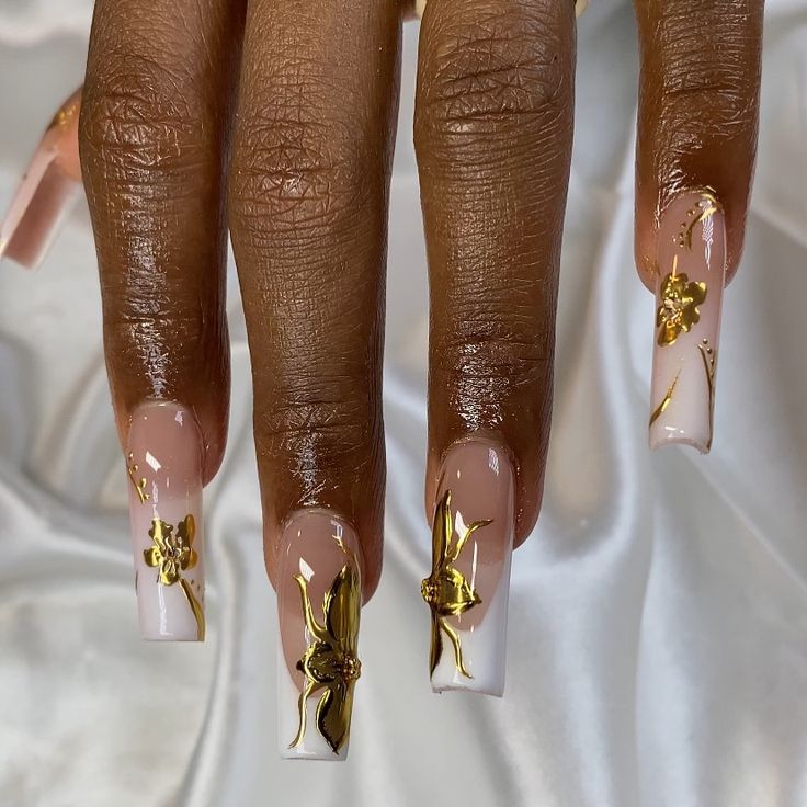 Chic Long Square Nail Design with Soft Pink, White, and Luxurious Golden Floral Accents.