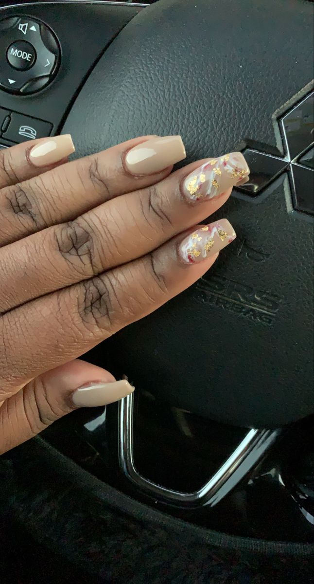 Sophisticated Nude Nail Design with Sparkly Accents and Marble Effects