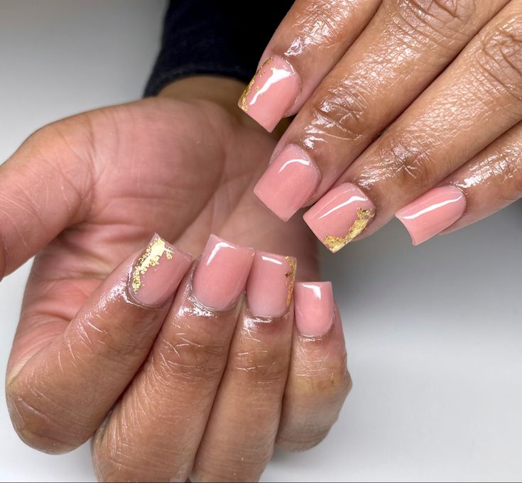 Chic Soft Pink Nail Design with Gold Foil Accents for a Luxurious Finish.