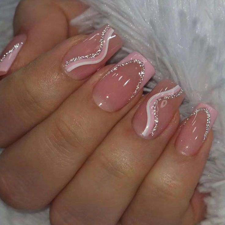 Sophisticated Elegant Nail Design: Soft Pink with White Swirls and Silver Accents.