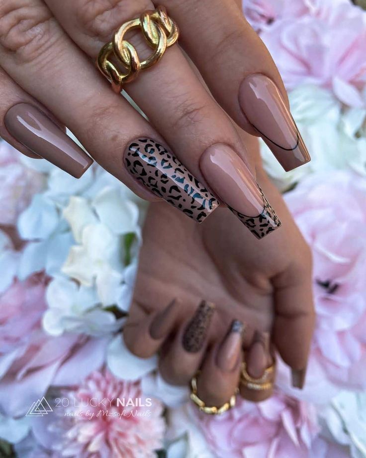 Chic Nude Nail Design with Matte and Smooth Finishes, Highlighted by a Leopard Print Accent and Gold Accessories.