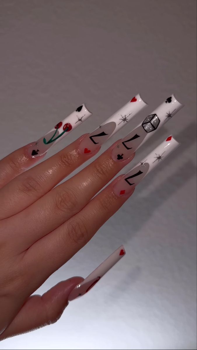 Playful and Whimsical Intricate Nail Design with Bold Symbols and Cherry Motifs.