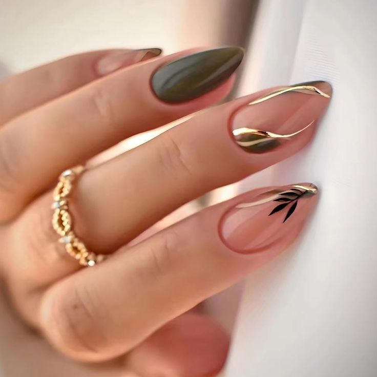 Elegant Deep Green and Nude Nail Design with Gold Accents and Leaf Motif