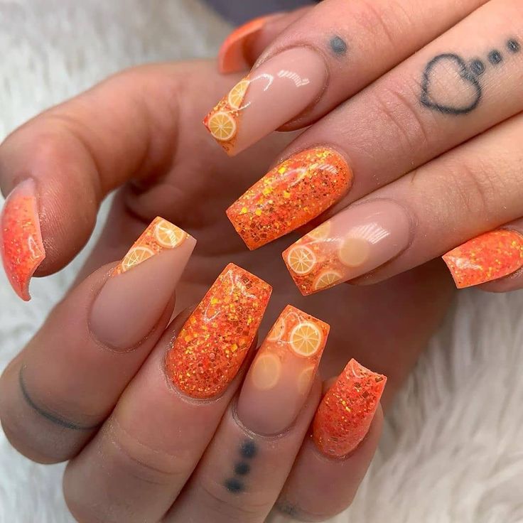 Vibrant Orange Nail Design with Glitter and Citrus Motifs for a Fresh Summer Vibe.