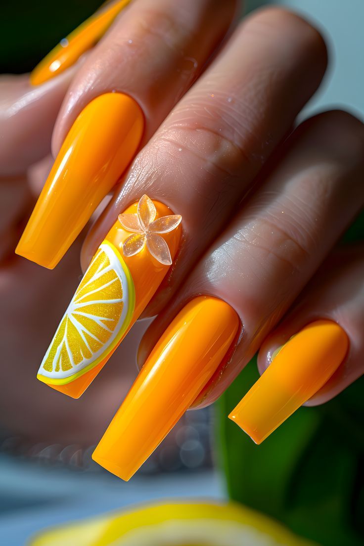 Bright Orange Citrus Nail Design with Lemon Slice and Floral Accent.