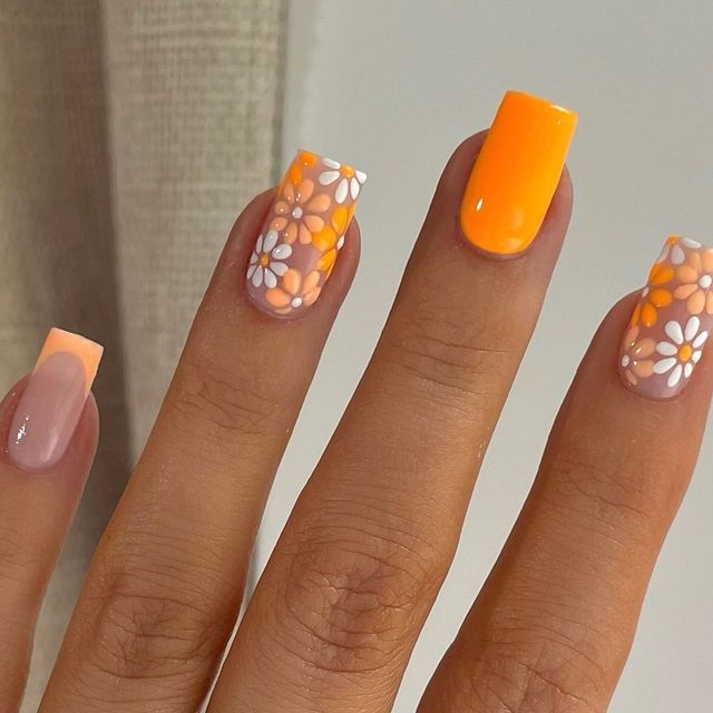 Vibrant Orange and Peach Floral Nail Design for a Trendy Spring/Summer Look.