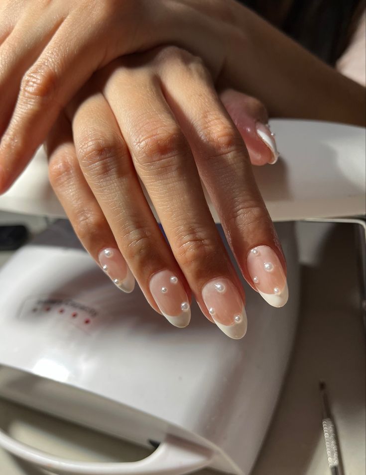 Chic French Tip Nail Design with Glossy Pearl Accents