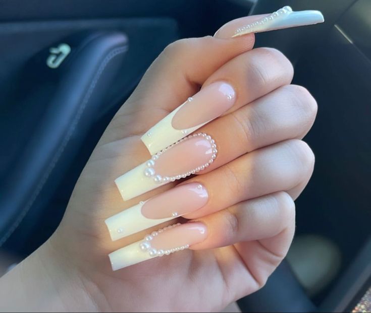 Sophisticated Ombre Stiletto Nails with Pearl Accents for a Glamorous Look.