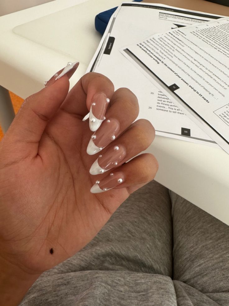 Sophisticated Ombre Nails with Pearl Embellishments and Almond Shape Design.