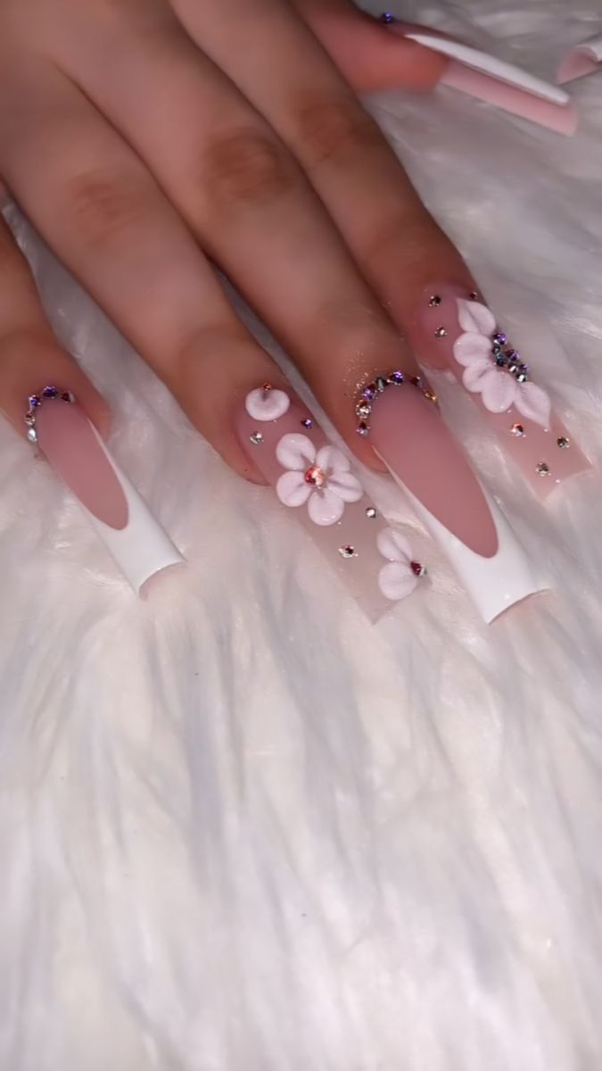 Elegant Soft Pink and White Nail Design with Floral Accents and Rhinestones