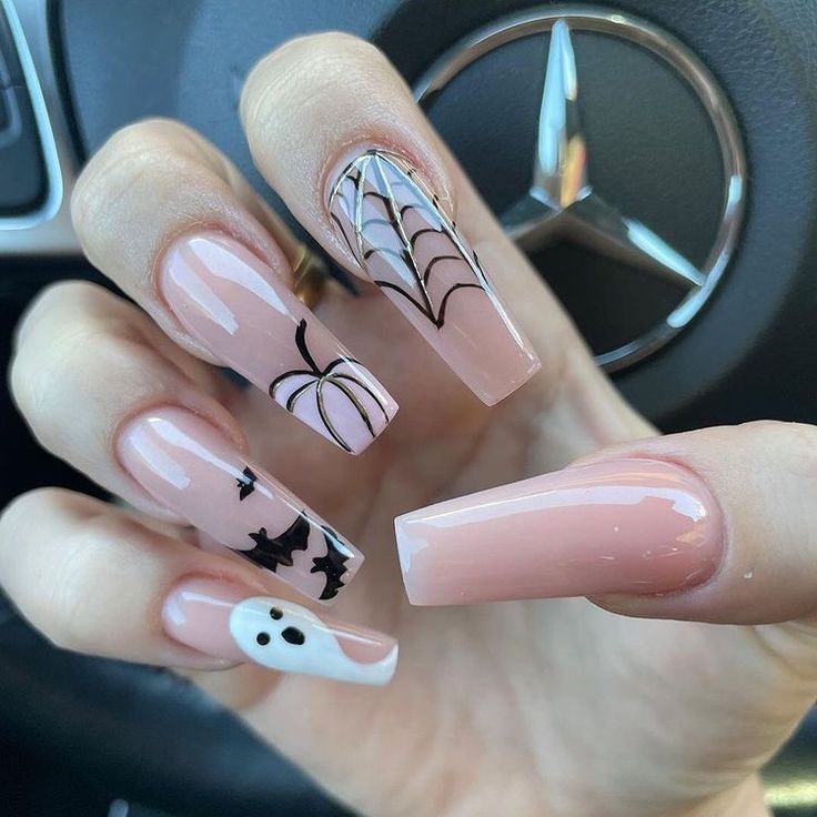 Chic Halloween Nail Design with Nude Base and Whimsical Accents