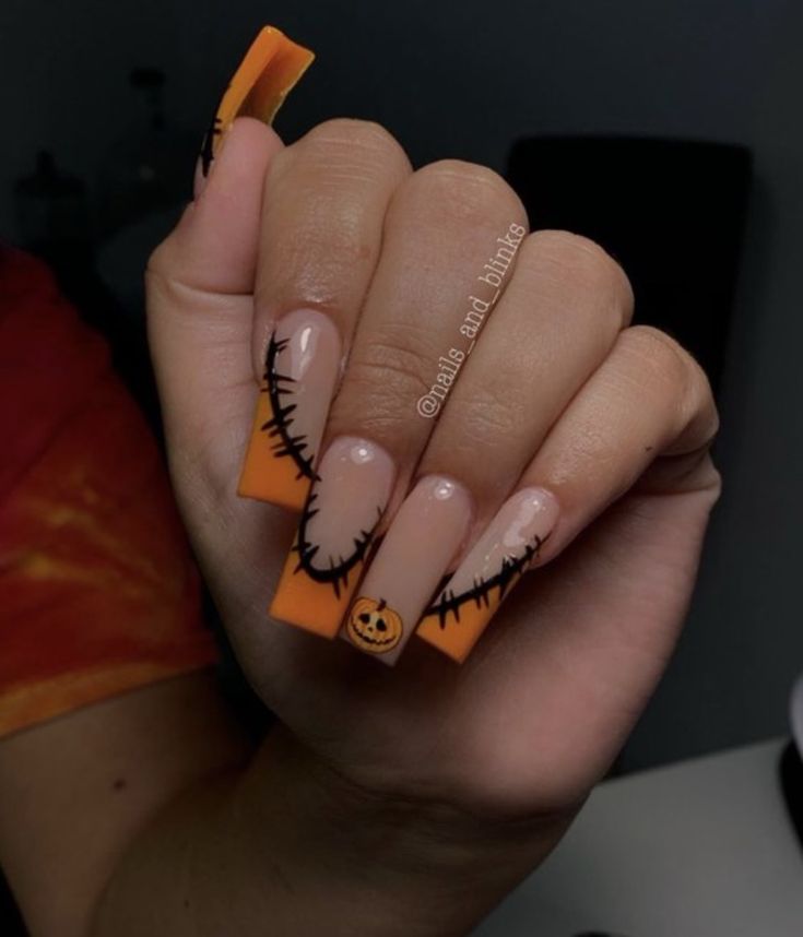 Festive Halloween Nail Design: Elongated Square Tips with Bold Orange Accents and Whimsical Pumpkin Motif.