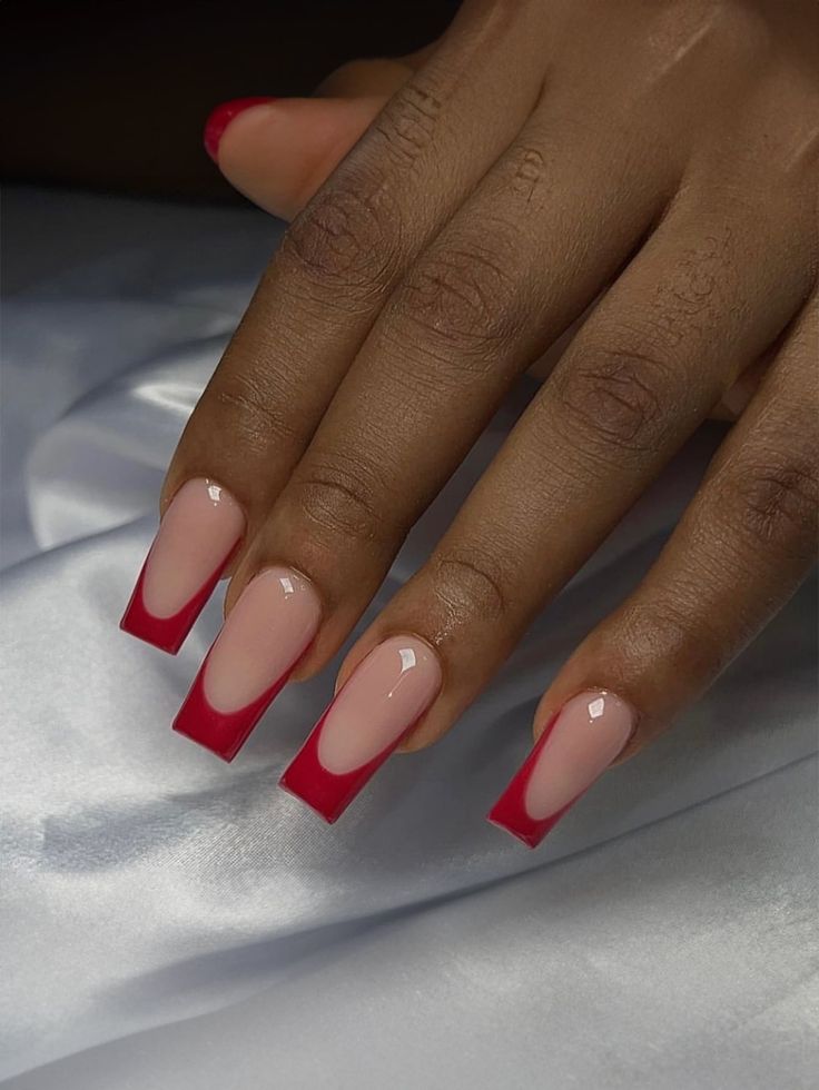 Chic Modern French Tip: Soft Nude Base with Bold Red Tips.