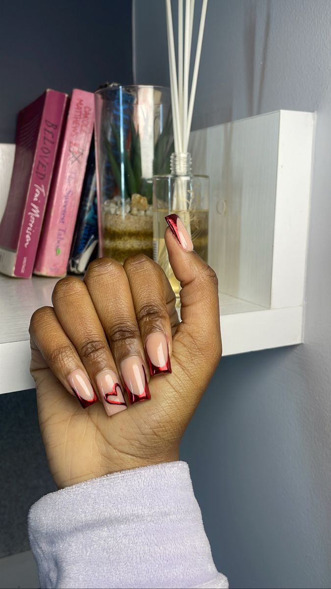 Chic Gradient Nude to Bold Red Nail Art with Romantic Heart Accents.