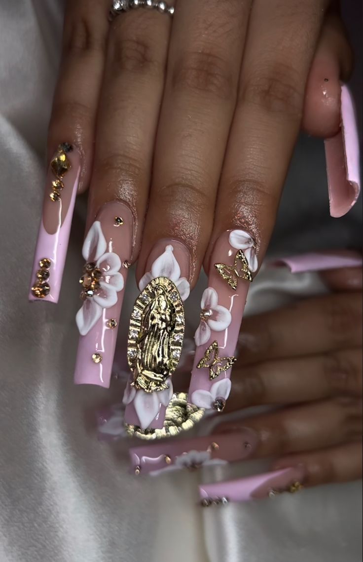 Luxurious Pink Nail Art with Floral Accents and Golden Highlights.