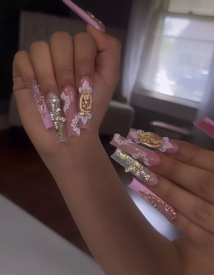 Sophisticated Pink Nail Design with Floral Accents and Gold Foil Embellishments.