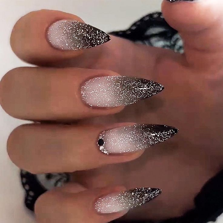 Glamorous Ombre Nail Design: Soft Pink to Deep Black Gradient with Glitter and Pointed Elegance.