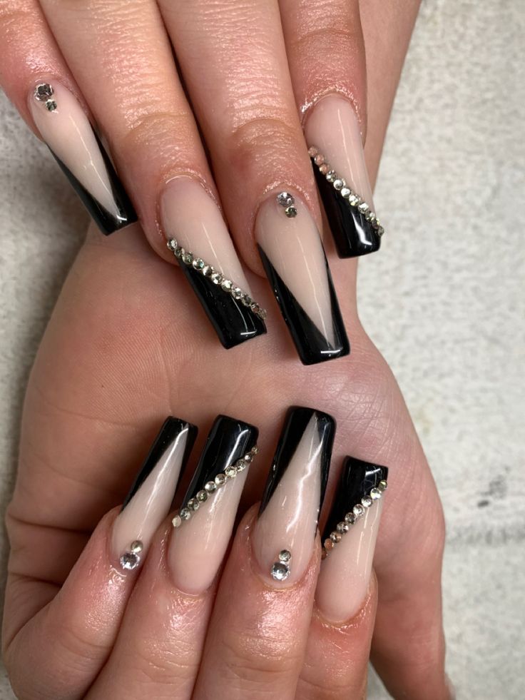 Chic Black and Nude Geometric Nail Design with Sparkling Rhinestones.