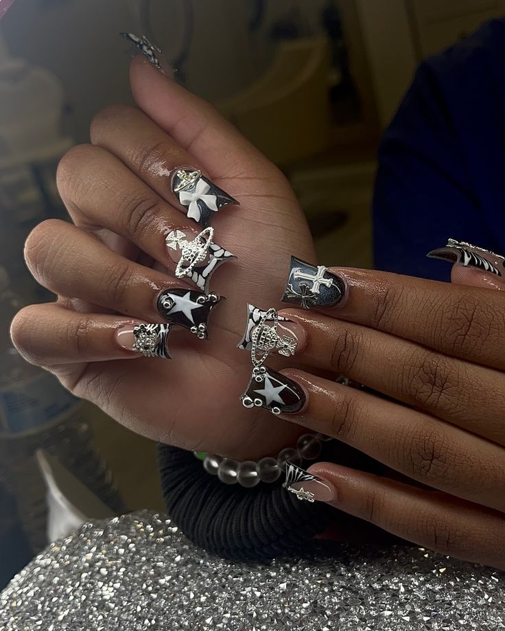 Striking Black and White Nail Design with Unique 3D Embellishments for a Bold Look.