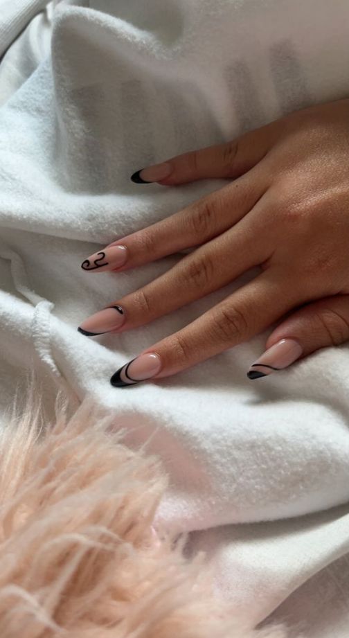 Sophisticated Nude and Black Elegant Nail Design with Artistic Accents.