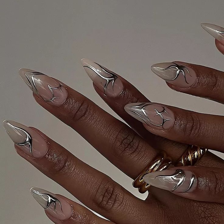 Sophisticated Nail Art: Elegant Nude Base with Striking Silver Patterns.