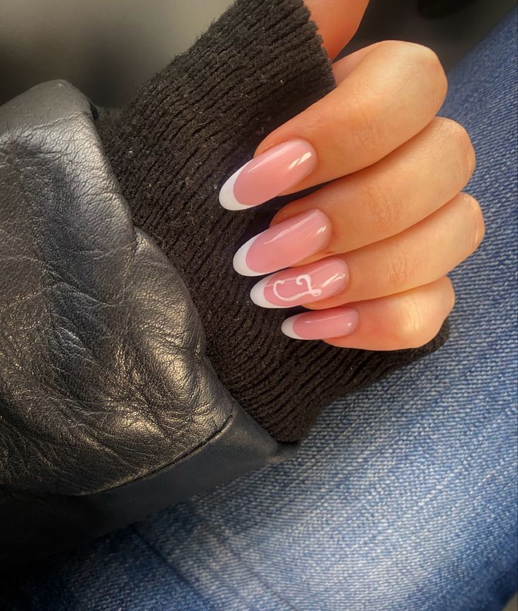 Sophisticated Soft Pink Nails with Classic White French Tips and Playful Accent.