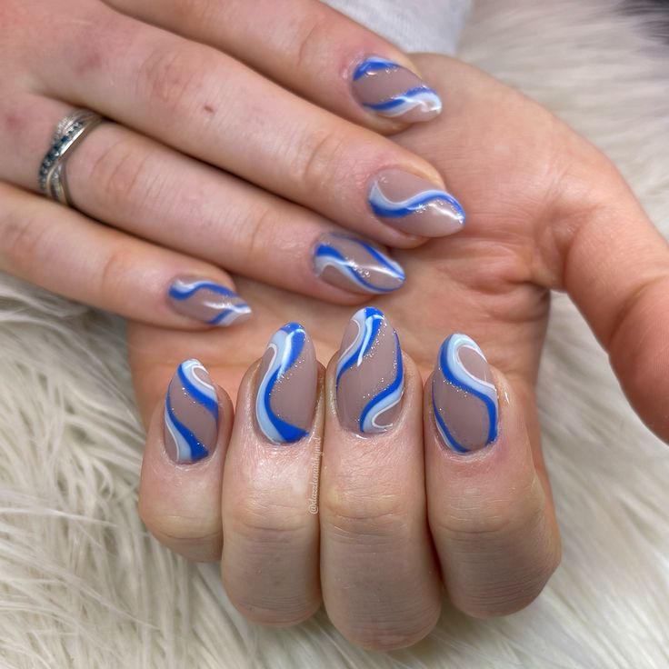 Trendy Light Blue and White Wave-Patterned Nail Art for a Stylish Look.