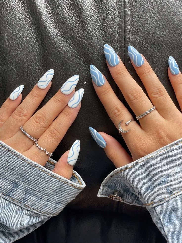 Chic Almond-Shaped Nails with Wavy Blue and White Design for Effortless Style.