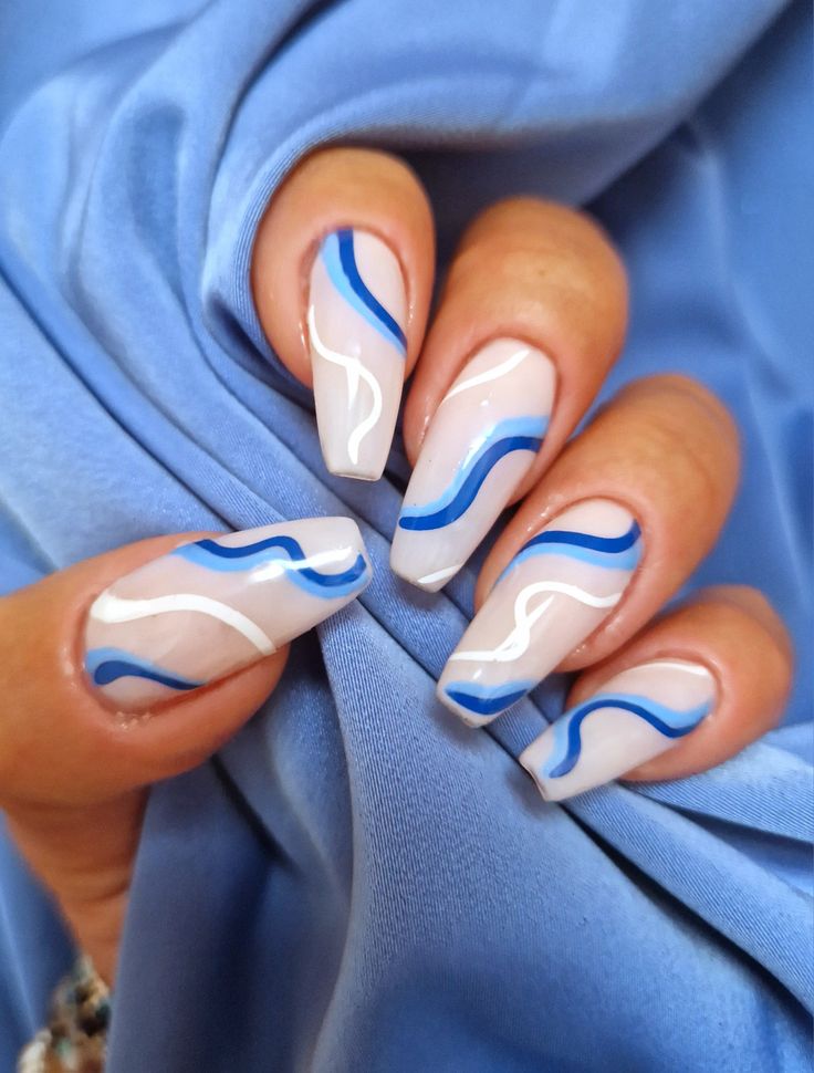 Chic Blue Wave Nail Art: Elegant Fluid Patterns with Glossy Finish.