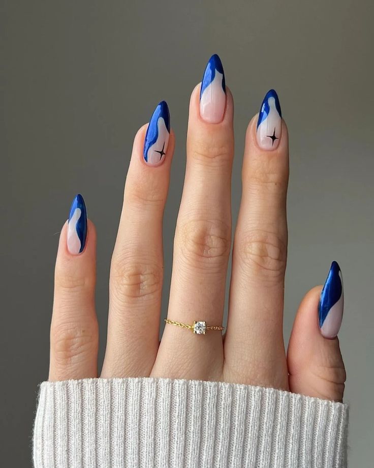 Elegant Blue and Nude Almond Nail Design with Eye-Catching Tips and Unique Detailing.