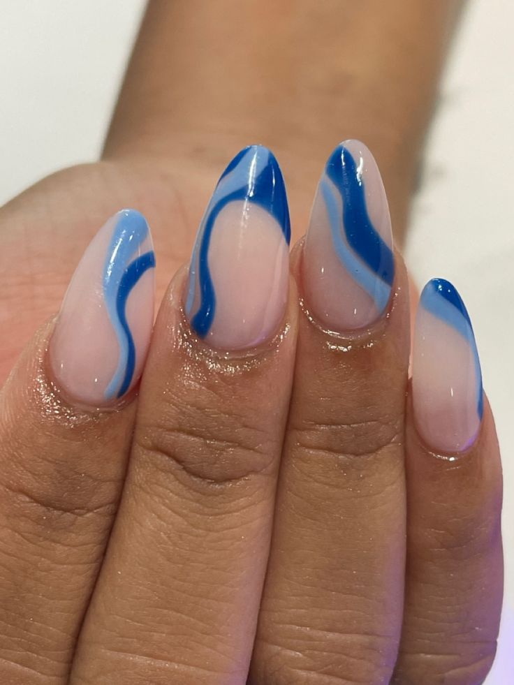 Elegant Soft Pink Nail Art with Fluid Blue Lines and Artistic Patterns