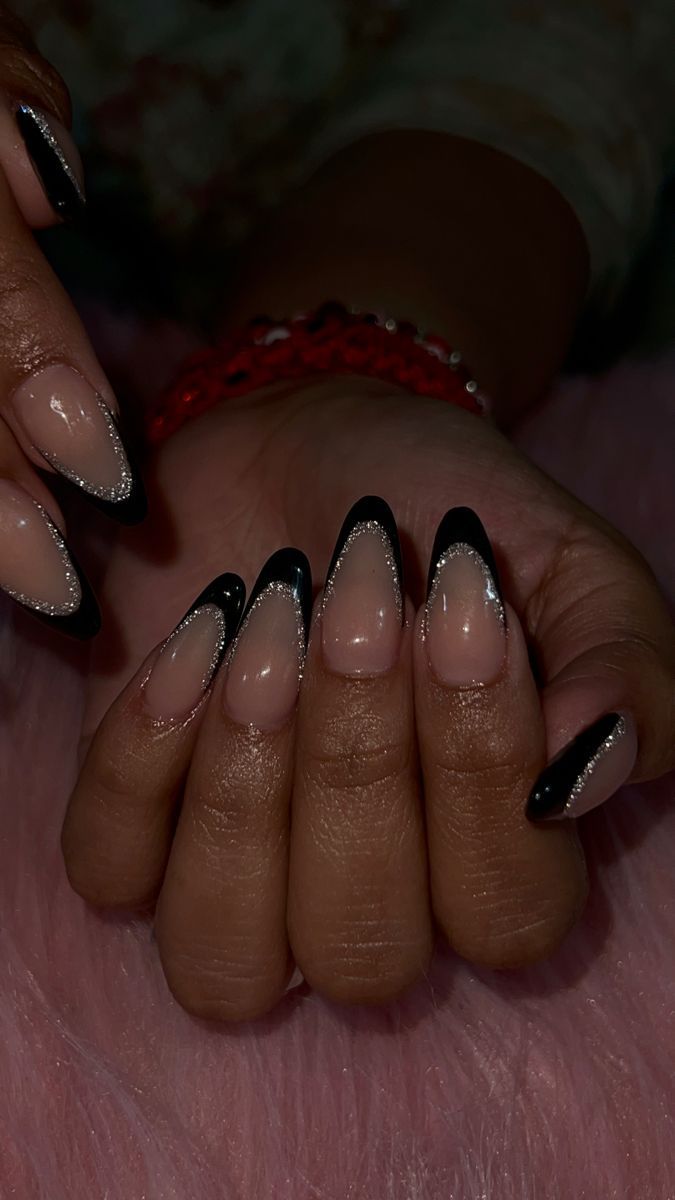 Chic Black Tipped Nude Nails with Silver Accents: A Sophisticated Twist on the Classic French Manicure.