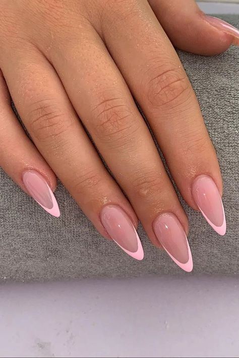 Chic Modern French Manicure: Elegant Almond-Shaped Nails with Soft Pink Base and Striking White Tips.