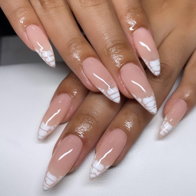 Elegant Almond-Shaped Nails: A Soft Nude Base with Striking White Design for Modern Aesthetics.