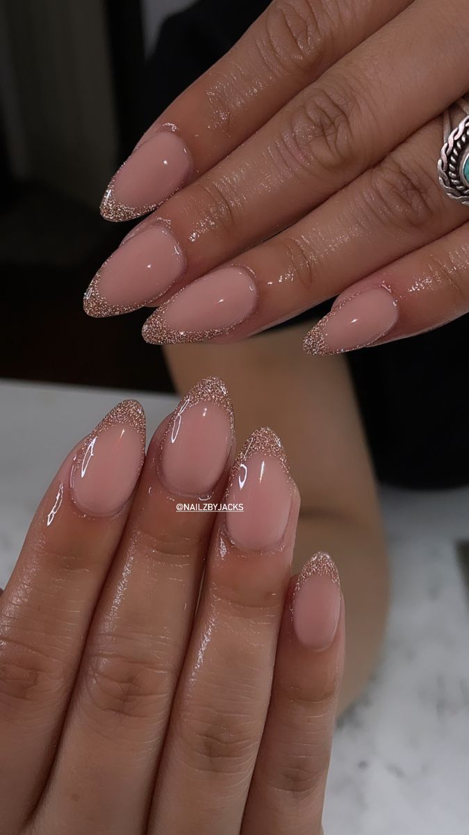 Elegant Almond-Shaped Nails with Subtle Glitter Tips and Soft Nude Base for Effortless Glamour.