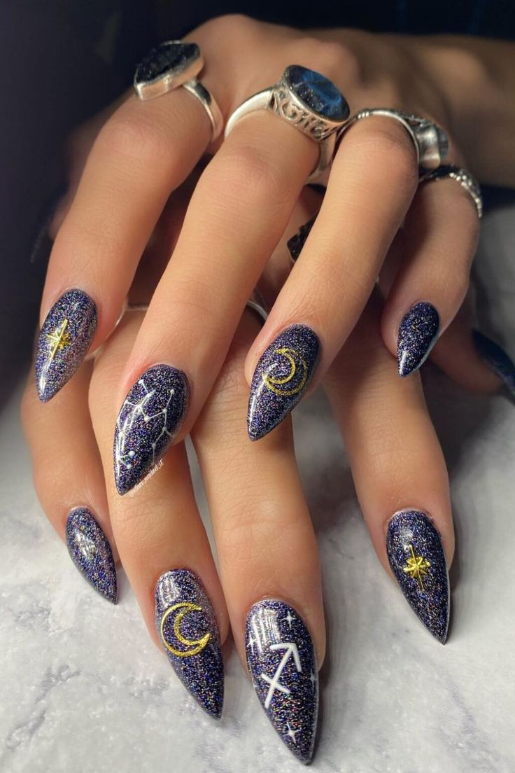 Celestial Stiletto Nails: Dazzling Deep Purple Glitter with Golden Moon and Star Accents