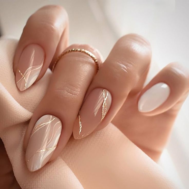 Chic Elegant Nail Design with Soft Nude Base, Delicate White Accents, and Sophisticated Gold Lines.